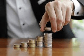 Homem contando moedas em referência a um empresário pegando o pró-labore.